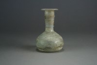 Lot 166 - A Roman glass bottle, circa 1st Century AD and...