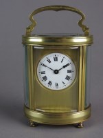 Lot 200 - A French oval brass cased carriage timepiece...