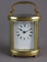 Lot 201 - A French oval brass carriage timepiece with...