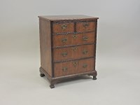 Lot 241 - A walnut crossbanded chest of drawers, George...