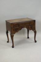 Lot 256 - A George I crossbanded walnut lowboy, the...