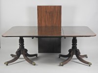 Lot 296 - A mahogany twin pillar dining table, late...