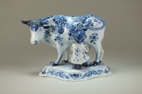 Lot 87 - A Dutch Delft blue and white group of a seated...