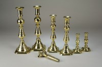 Lot 157 - Six pairs of brass candlesticks, beer tap and...