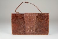 Lot 160 - A crocodile skin handbag, with central zipped...