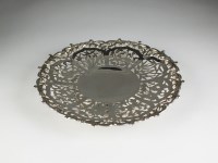 Lot 50 - A white metal pierced shallow dish, with...
