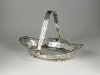Lot 69 - A George III silver swing handled sugar basket...
