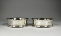 Lot 153 - A pair of George III silver wine coasters,...