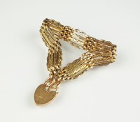 Lot 174 - A yellow metal four bar gate link bracelet,...
