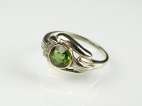 Lot 178 - A single green stone ring, collet set in white...