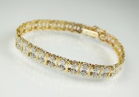 Lot 185 - A 9ct gold diamond set bracelet, designed as a...