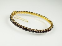 Lot 206 - A Bohemian garnet hinged bangle, designed as a...