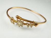 Lot 210 - An early 20th century seed pearl bangle, the...