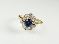 Lot 216 - A sapphire and diamond cluster ring, designed...