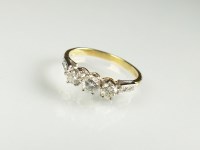 Lot 217 - An 18ct gold three stone diamond ring, the...