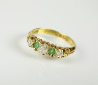 Lot 227 - An 18ct gold five stone emerald and diamond...