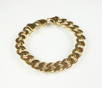 Lot 232 - A yellow metal flat curb link bracelet, with...