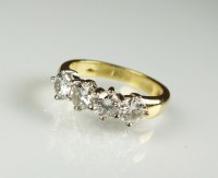 Lot 237 - An 18ct gold four stone diamond ring, the row...