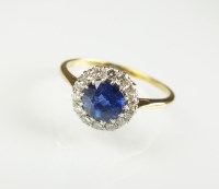 Lot 238 - A sapphire and diamond cluster ring, designed...