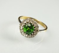 Lot 239 - A demantoid garnet and diamond cluster ring,...