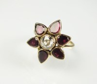 Lot 244 - A diamond and garnet floral cluster ring,...