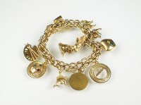 Lot 252 - A yellow metal fancy link charm bracelet, with...