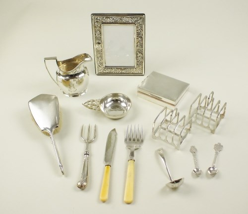 Lot 7 - A pair of four division silver toast racks,...