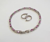 Lot 27 - A pink sapphire and diamond bracelet, designed...