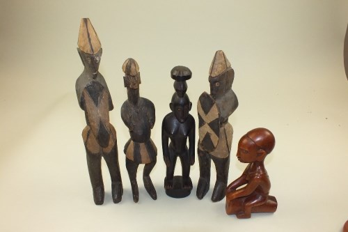 Lot 41 - A group of five carved wood African tribal...