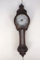 Lot 328 - A late Victorian oak cased aneroid barometer...