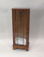 Lot 340 - A walnut veneered single door display cabinet...