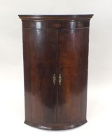 Lot 364 - A George III bow front mahogany two door wall...