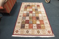 Lot 400 - A red ground Kashmir all over floral design...