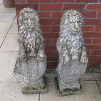 Lot 418 - A pair of composite stone heraldic lions each...