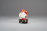 Lot 32 - A Chinese carnelian agate carved figure of a...
