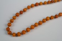 Lot 175 - An amber bead necklace Late Qing/early...