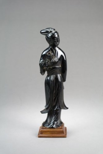 Lot 179 - A Chinese red amber figure of Guanyin Late...