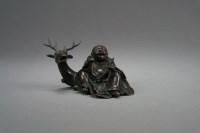Lot 188 - A Chinese bronze figural brush rest 18th/19th...