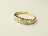 Lot 205 - An 18ct gold graduated Princess cut diamond...