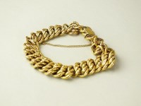 Lot 226 - A yellow metal hollow multi-curb link bracelet,...