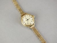 Lot 256 - A 9ct gold bracelet wristwatch, the circular...