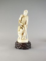 Lot 298 - A large Japanese ivory okimono of a farmer and...