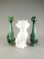 Lot 329 - A pair of green glazed models of cats, with...