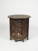 Lot 521 - A Middle Eastern carved hardwood octagonal top...