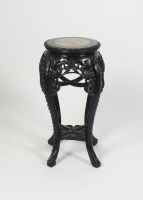 Lot 524 - A Chinese hardwood and marble inset urn stand...