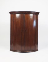 Lot 574 - An early 19th century mahogany bowfront wall...