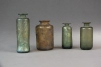 Lot 136 - A small grouping of Roman glass bottles,...