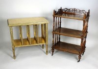 Lot 214 - A Victorian walnut three tier what-not, each...