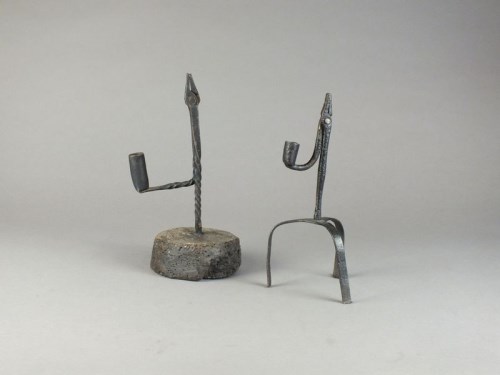 Lot 72 - A wrought iron rush light and taper stick...