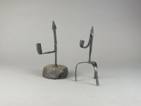 Lot 72 - A wrought iron rush light and taper stick...